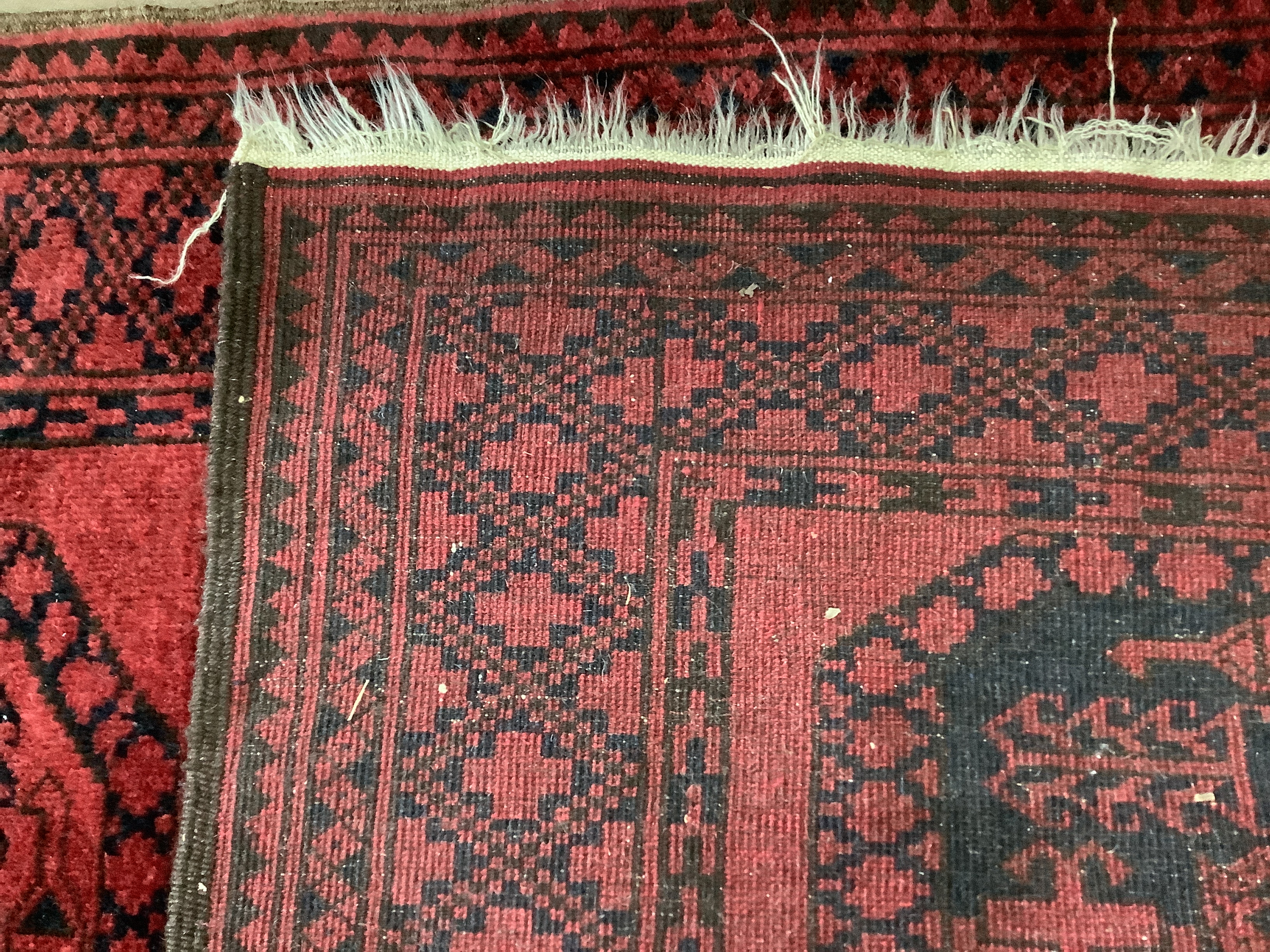 Two Afghan red ground rugs, larger 170 x 120cm